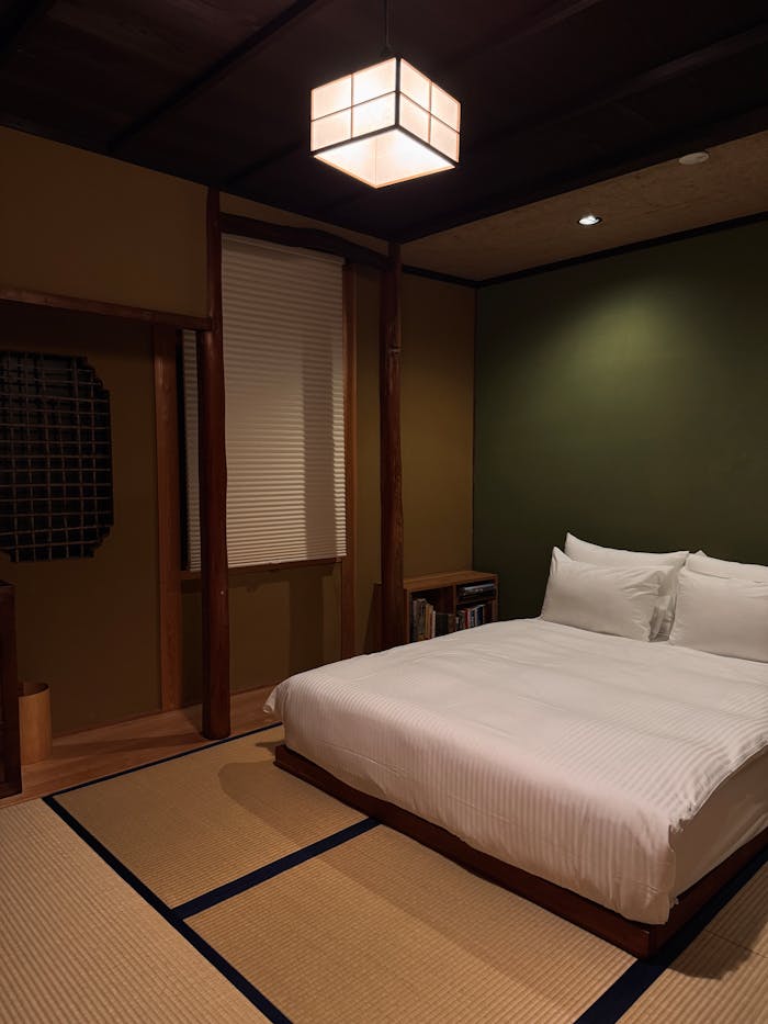 A serene Japanese-style bedroom featuring tatami mats and soft lighting.
