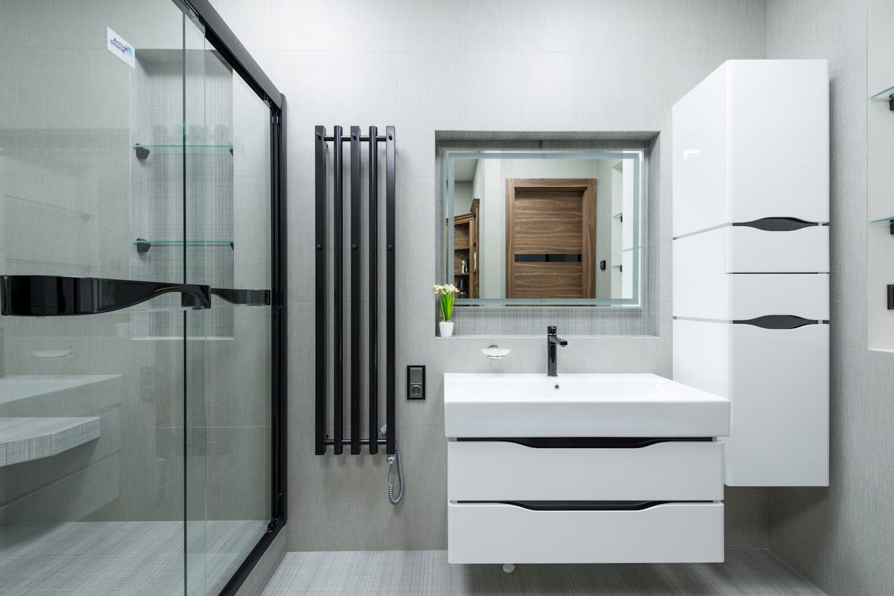 A sleek and stylish modern bathroom featuring a glass shower and elegant fixtures.