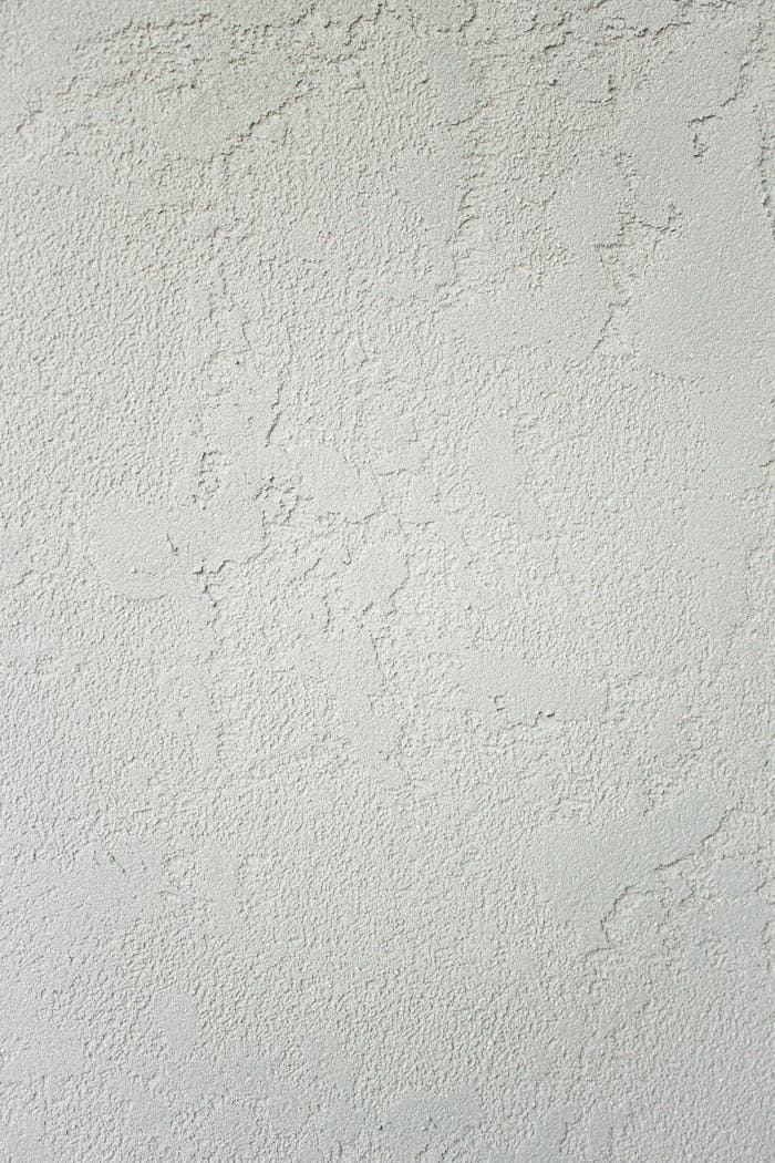 team-01 Minimalist clean background of white wall with roughness and cracks with scratches in studio in daylight